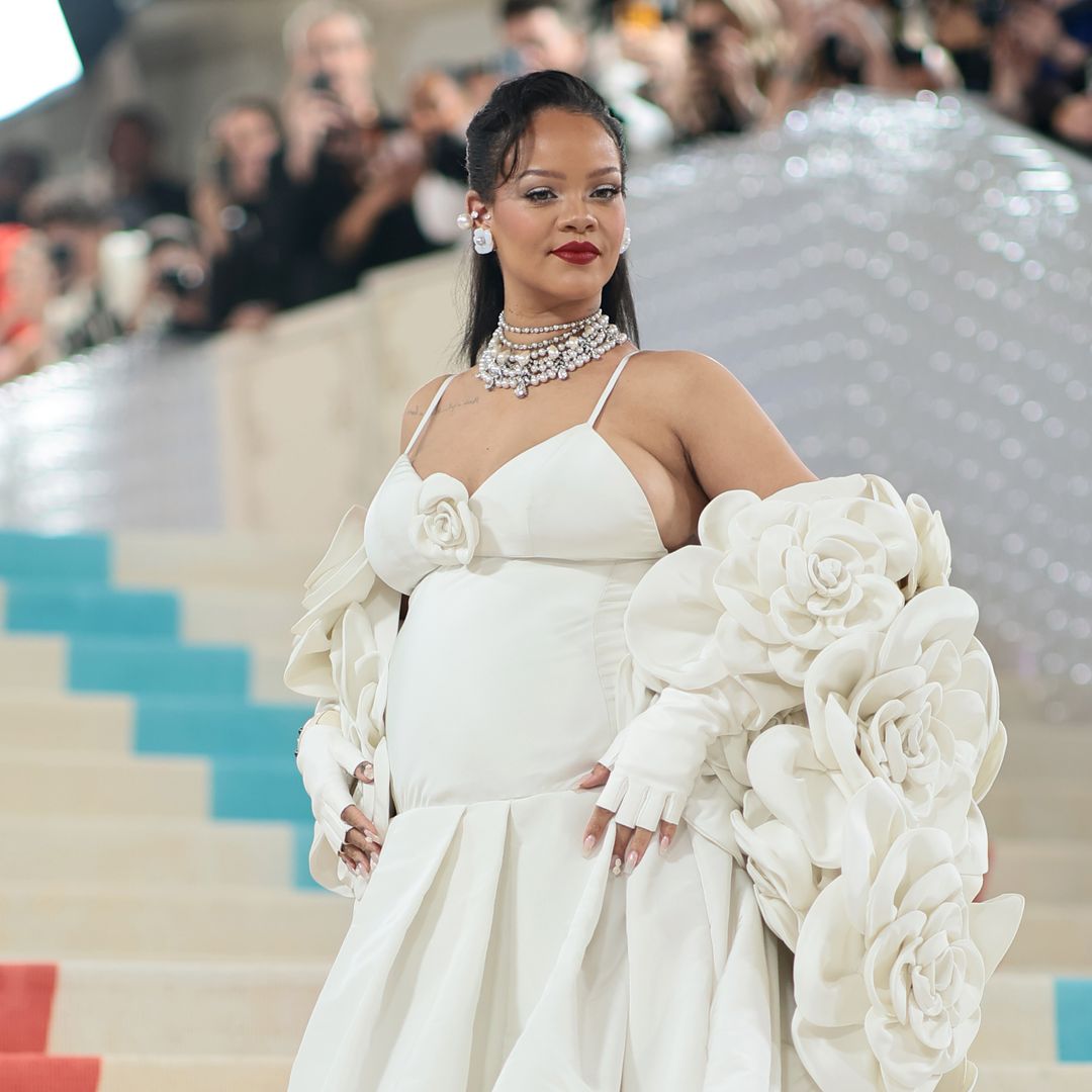 Rihanna attends The 2023 Met Gala in a white floral dress