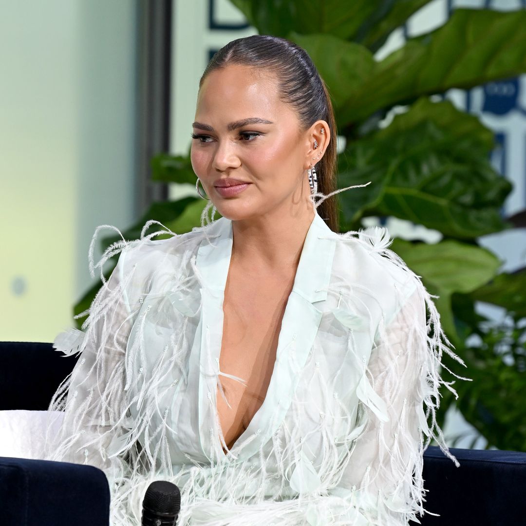 Chrissy Teigen looks like a swan in feathered mini dress as she welcomes new family member