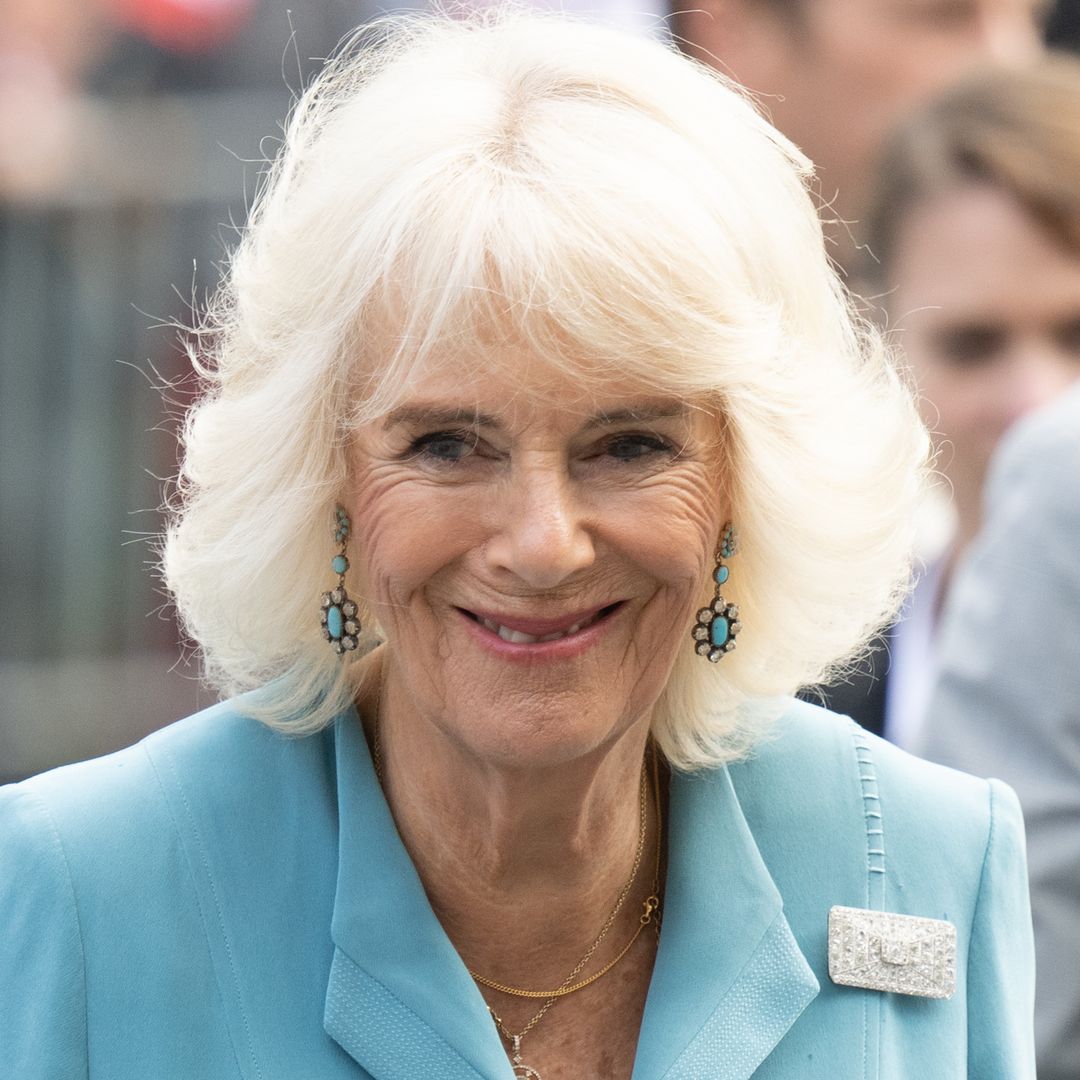 Queen Camilla nails understated elegance in lace-adorned co-ord and knee-high boots