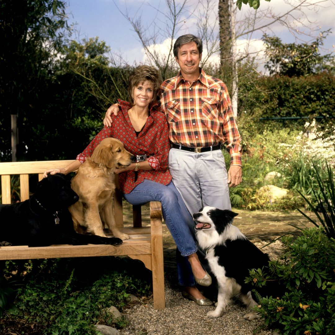 American actress Jane Fonda and husband, American author Tom Hayden (1939 - 2016) pose for a portrait with their dogs in Los Angeles, California, circa 1985.