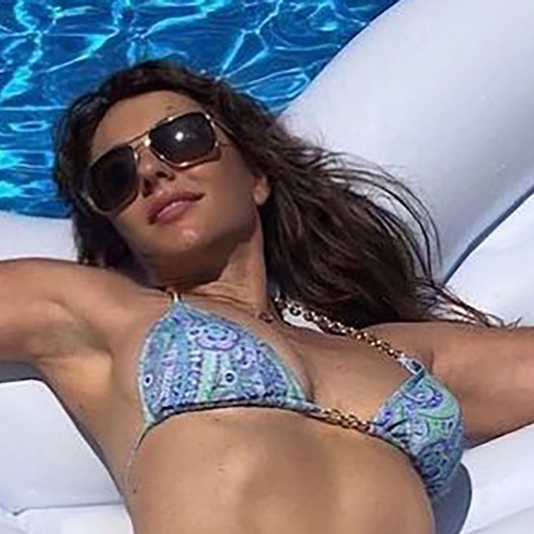 Elizabeth Hurley shows off toned midriff in beach photo as she introduces new family member