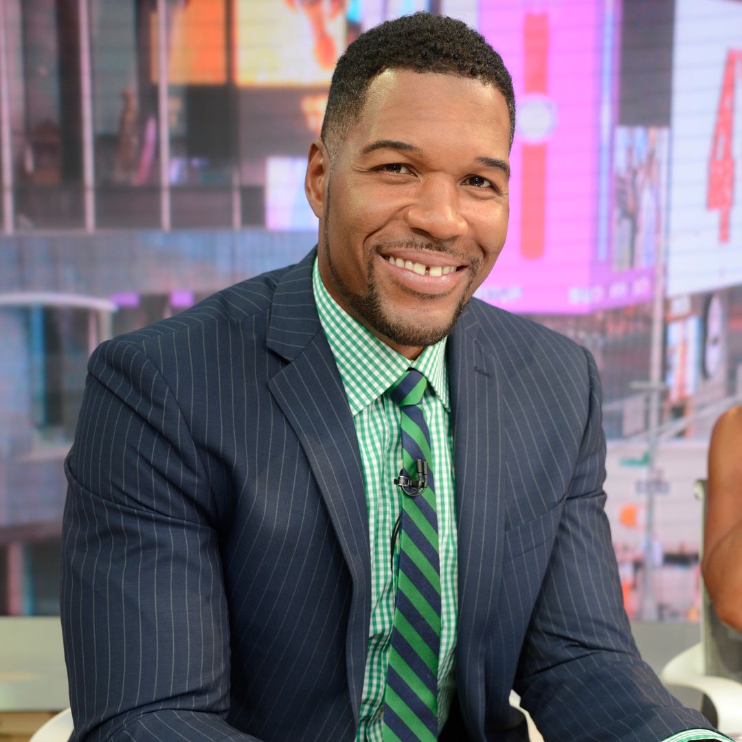 Michael Strahan poses with rarely-seen family members as he marks personal achievement