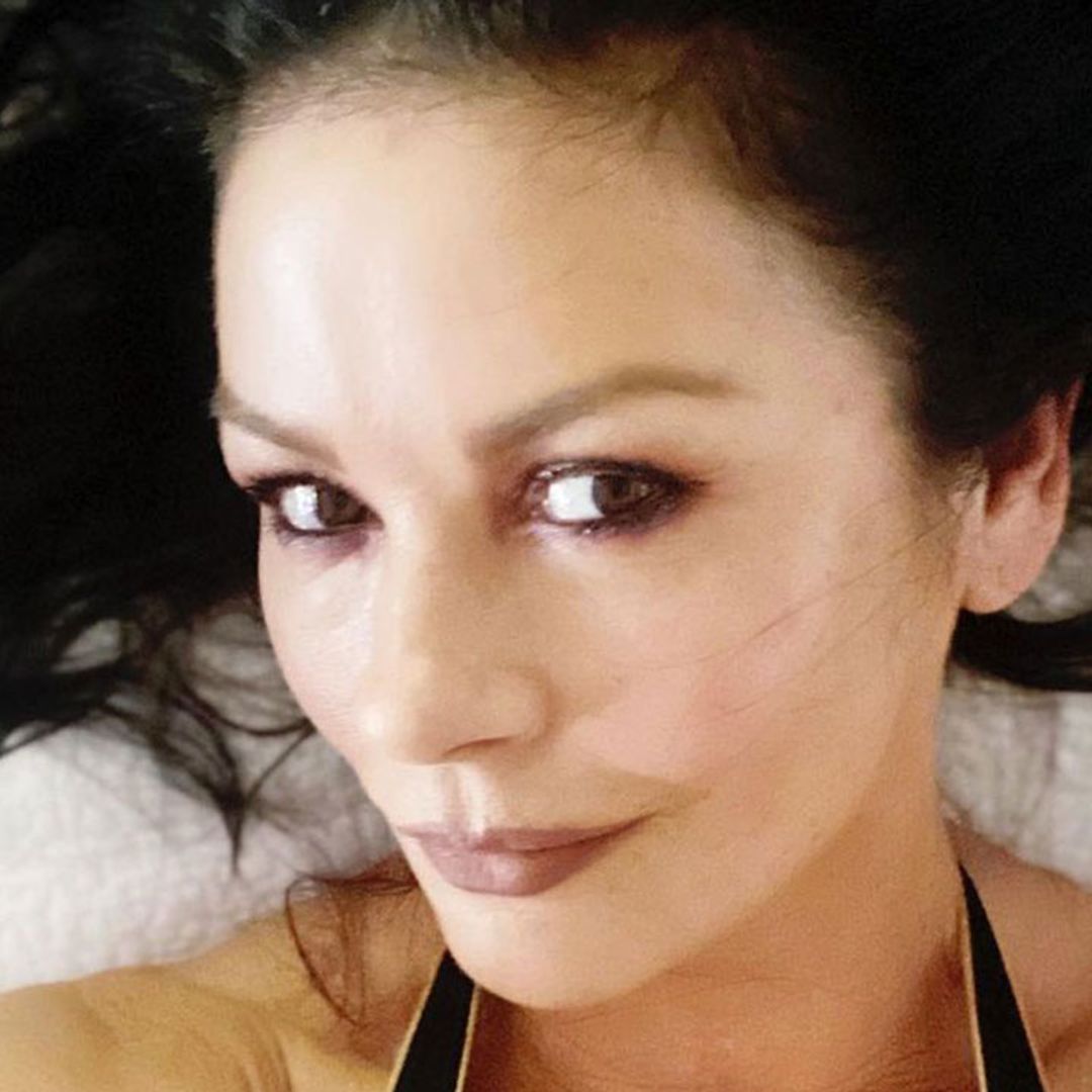 Catherine Zeta-Jones stuns in plunging black swimsuit as she relaxes in a jacuzzi on board a yacht