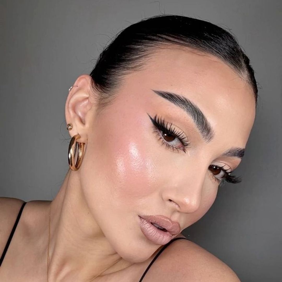 woman with a slicked back bun and highlighter