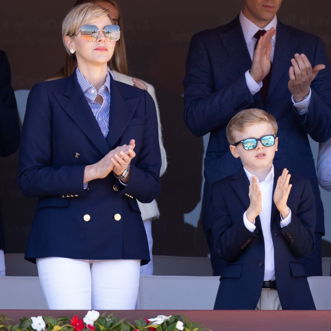 Princess Charlene and Prince Jacques clapping in sunglasses