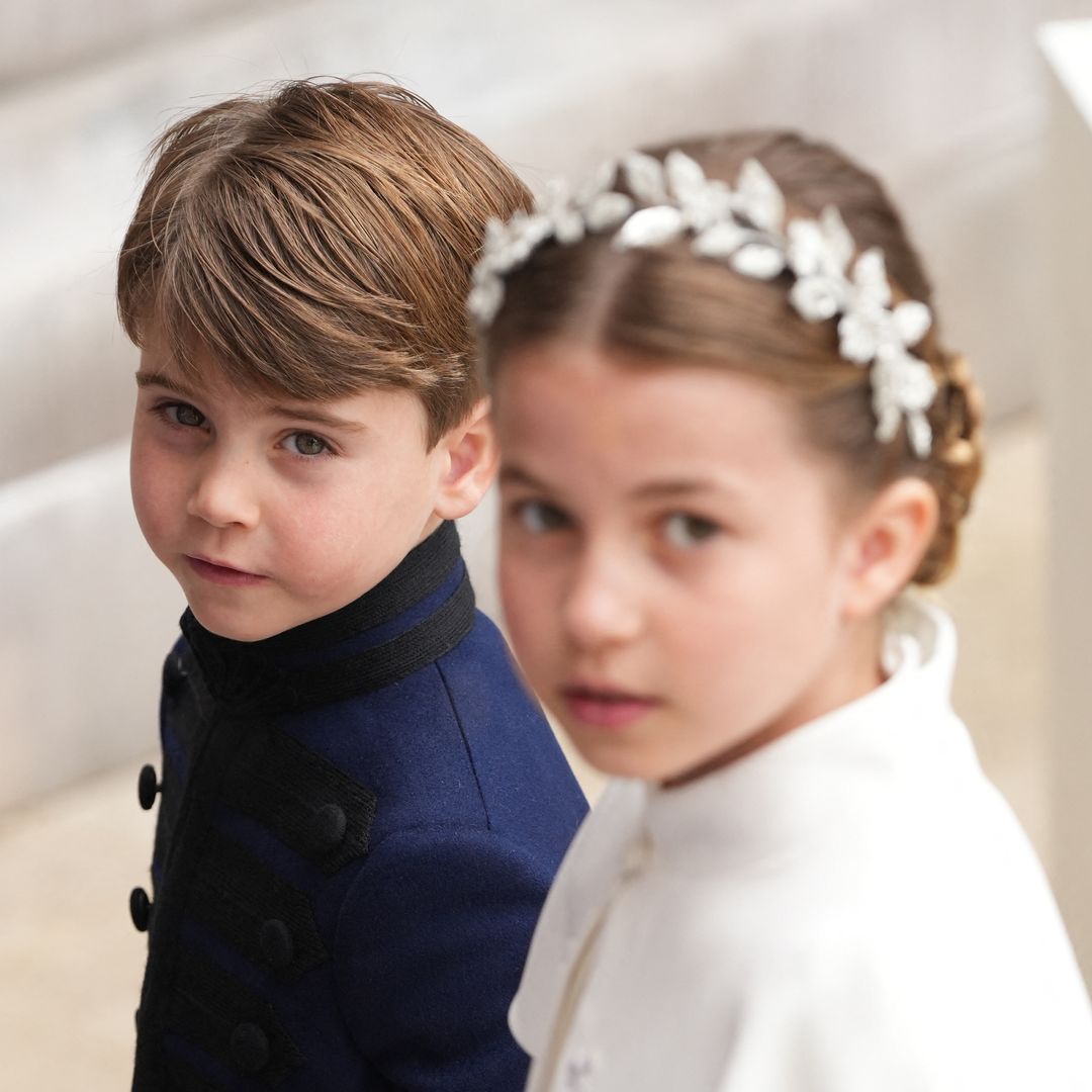 Princess Charlotte is doting older sister as she holds Prince Louis' hand