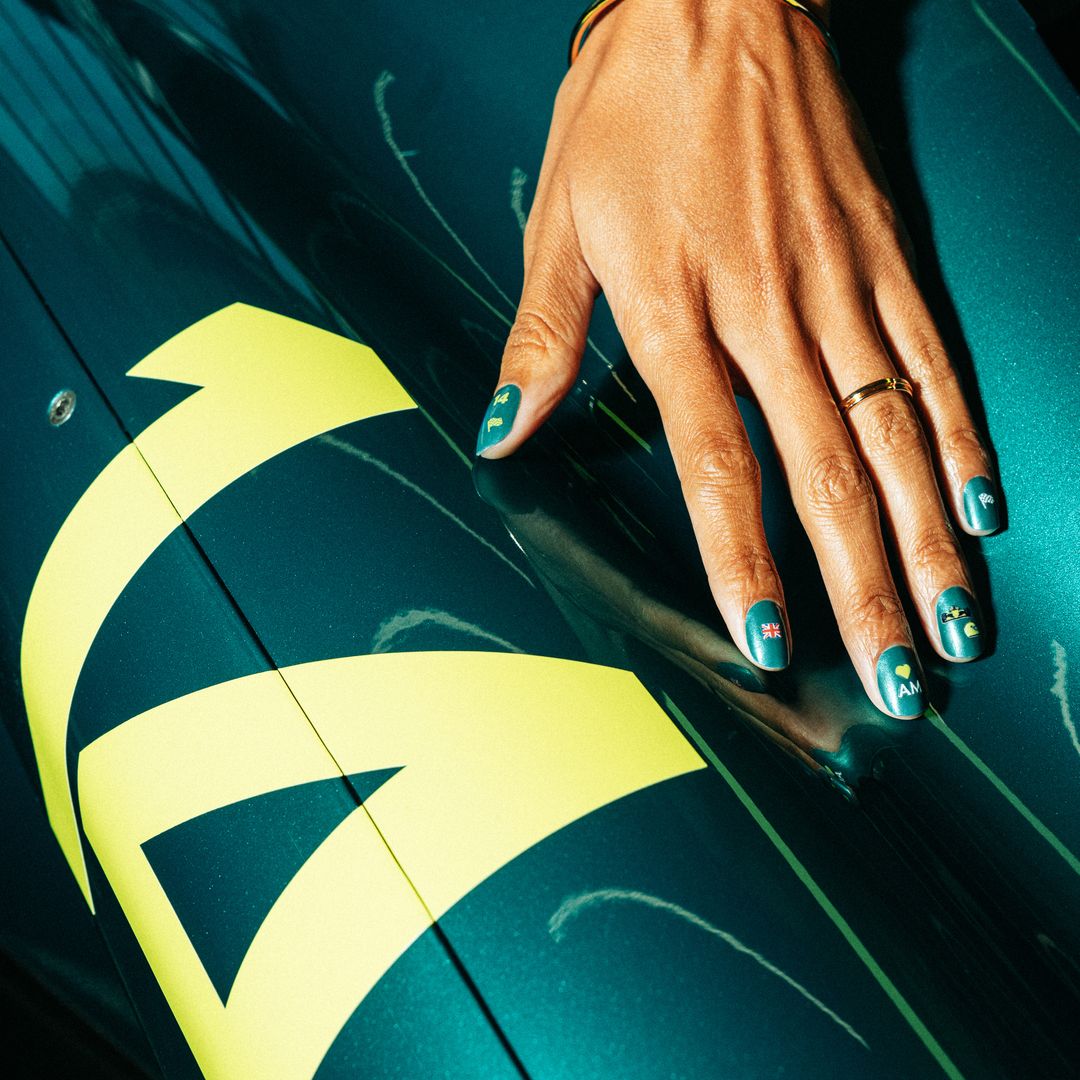 Glaze nails green next to the green racing car 