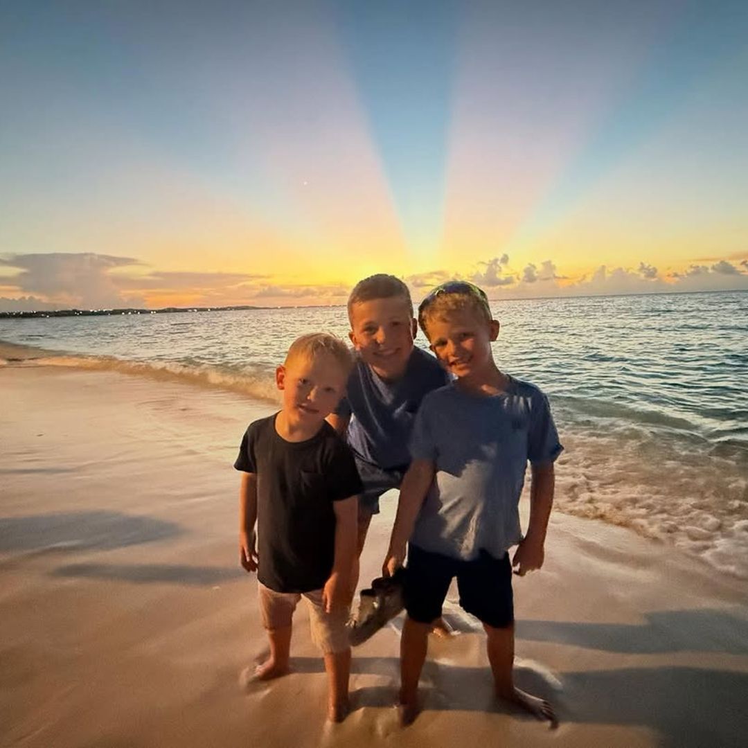 Dylan Dreyer and Brian Fichera's sons Calvin, Oliver and Rusty pose for a photo on a beach with the sunset behind them, shared on Instagram