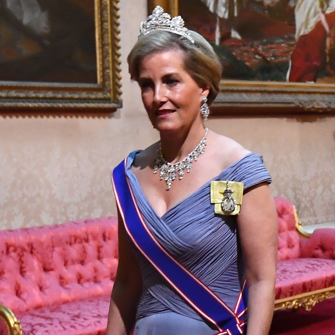 Duchess Sophie in a blue dress with a sash and a diamond tiara