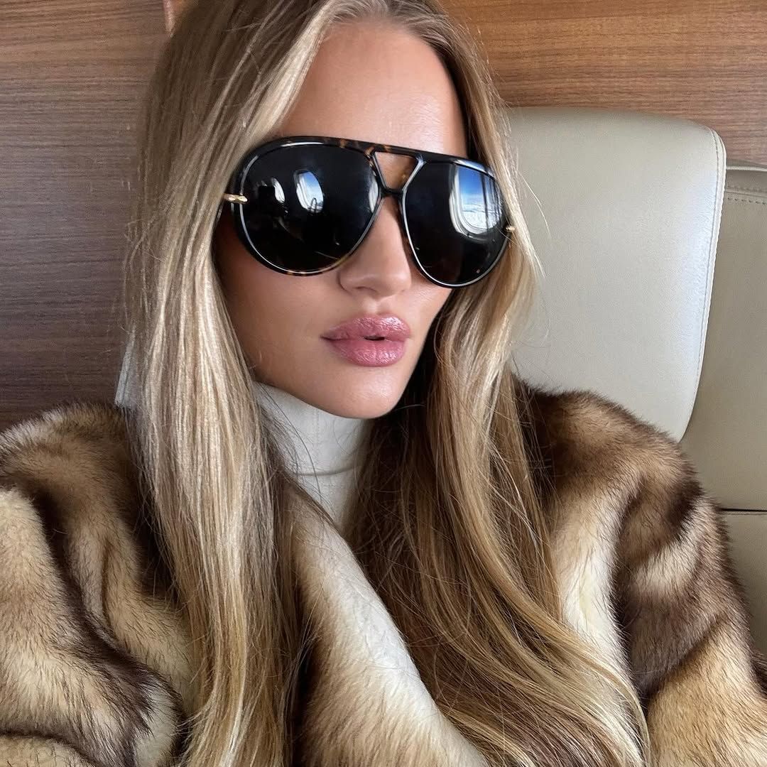 Rosie hunington with a brown fur coat and black sunglasses 