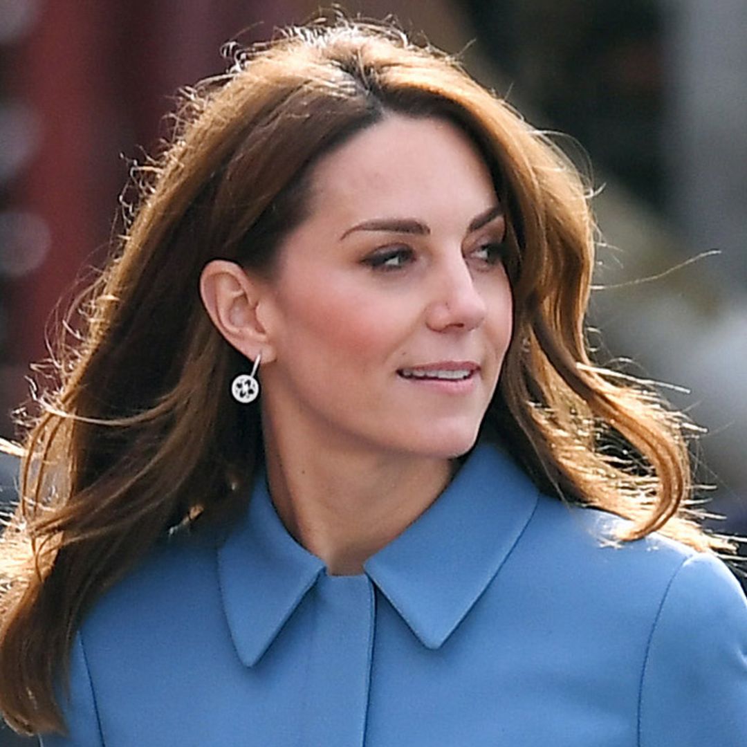 Kate Middleton wears a sky blue coat by Alexander McQueen as she meets Sir David Attenborough