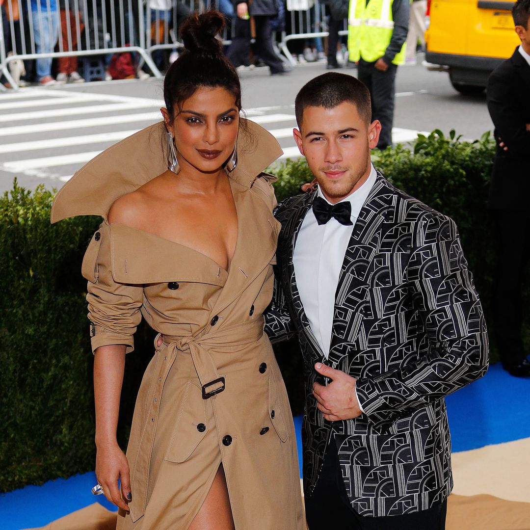 Nick and Priyanka stood next to each other smiling at the camera