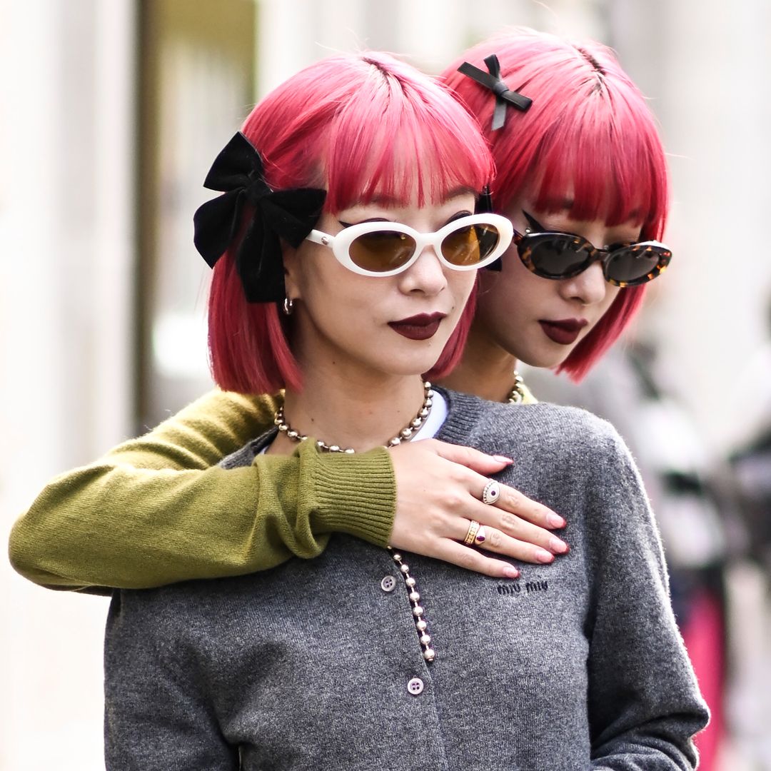 Ami Suzuki and Aya Suzuki showcasing bow hair accessories in Paris