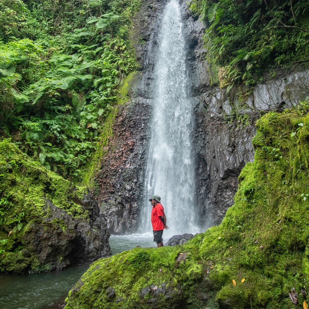 tour guide standing in front of waterfall in Vanuatu 