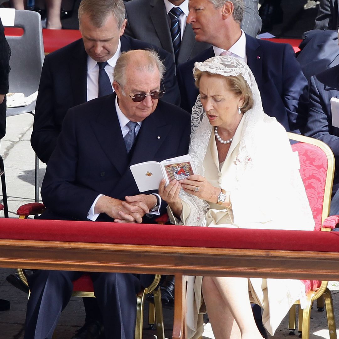 Queen Paola and King Albert II of Belgium attend the John Paul II Beatification Ceremony in the Vatican City, 2011. Queen Paola wears a white skirt suit and white lace veil, King Albert wears a suit and tie