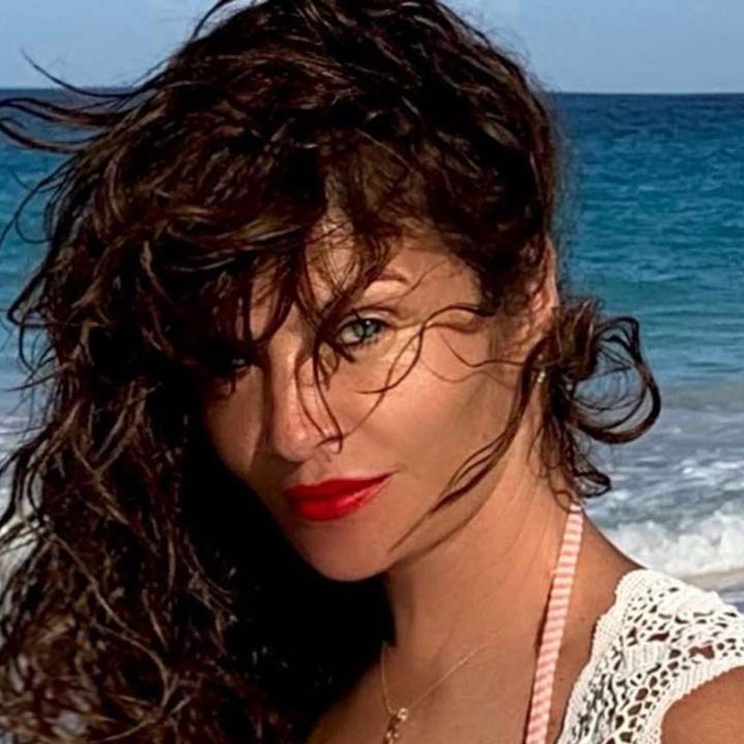 Helena Christensen upstaged by surprise companion during outdoor soak in daring swimsuit