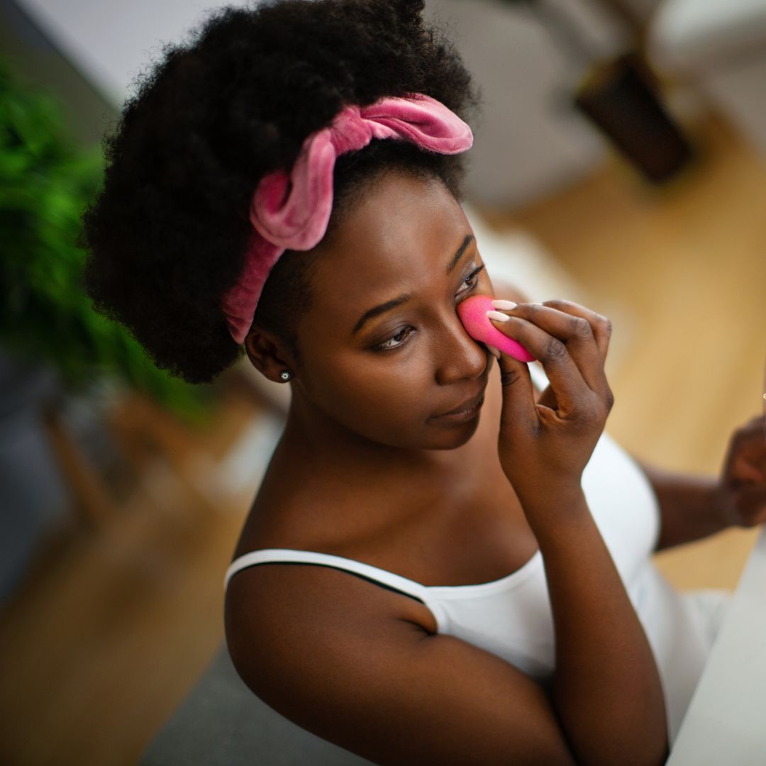 applying under eye concealer and powder.