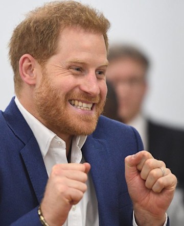 Prince Harry looking excited as he wears silver wedding ring