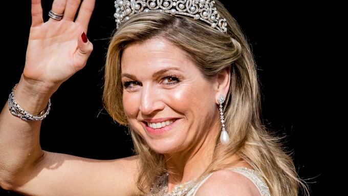 Queen Maxima waving in a tiara and sparkly dress