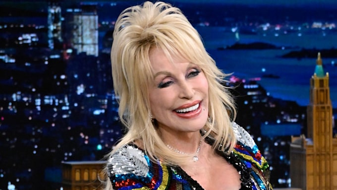 Dolly Parton smiling in a sparkly dress
