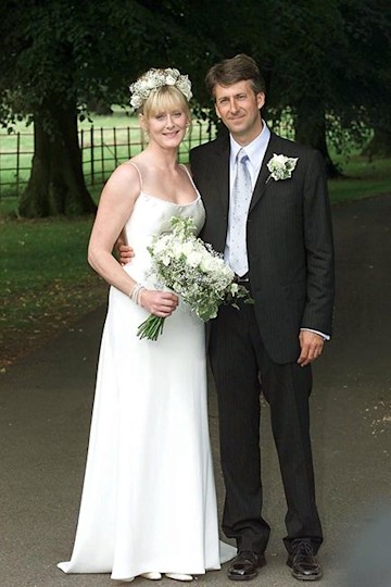 Sarah and Peter smiling on their wedding day