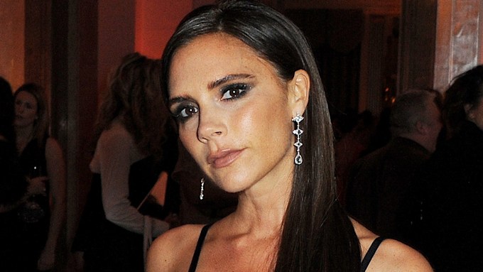 Victoria Beckham rocks a strappy dress and vampy smokey eye makeup
