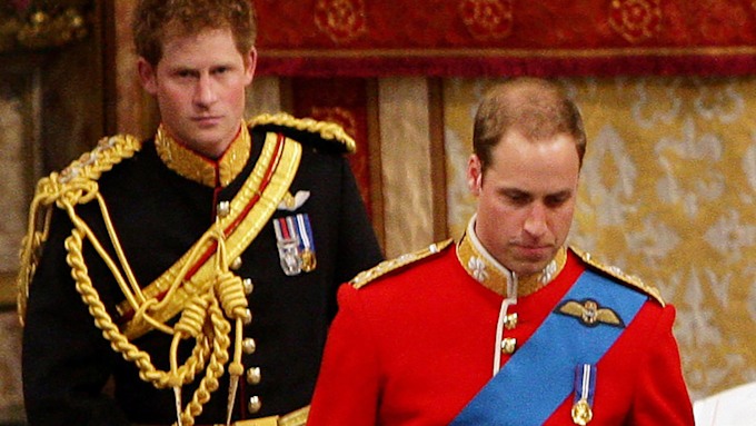 Prince Harry in a black uniform behind the groom Prince William