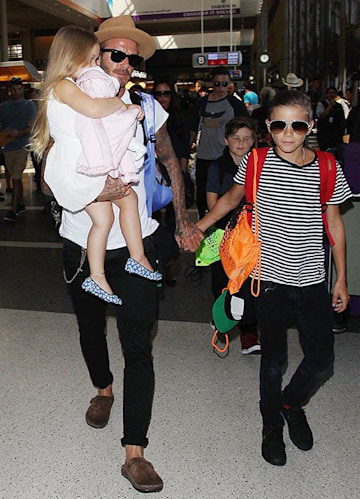 David and Victoria Beckham return home to London following their summer ...