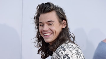 Harry Styles smiling in floral suit 