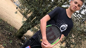 Romeo Beckham with tennis racket