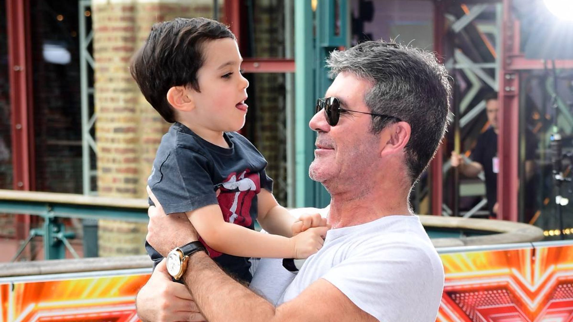 Simon Cowell cheered up by son Eric during rare appearance following