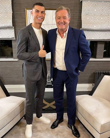 Piers Morgan and Cristiano Ronaldo pose together and smile for the camera