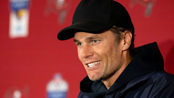 Tom Brady smiling in a cap