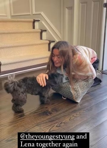 Kelly Ripa's daughter Lola hugging their family dog 