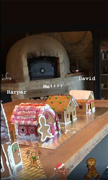 A photo of Harper, Victoria and David's gingerbread houses