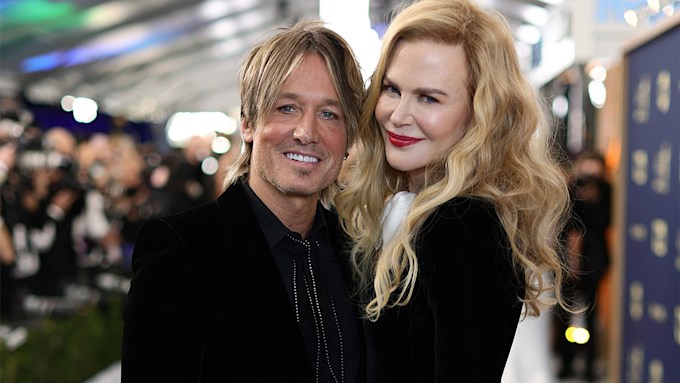 Keith Urban and Nicole Kidman cuddle while both dressed in black