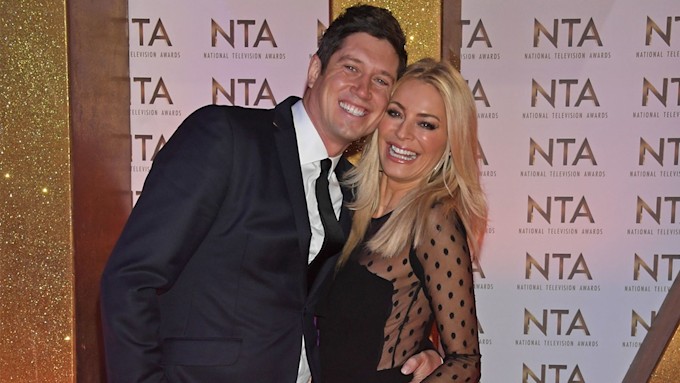 Tess Daly and Vernon Kay smiling on the red carpet at the NTAs.