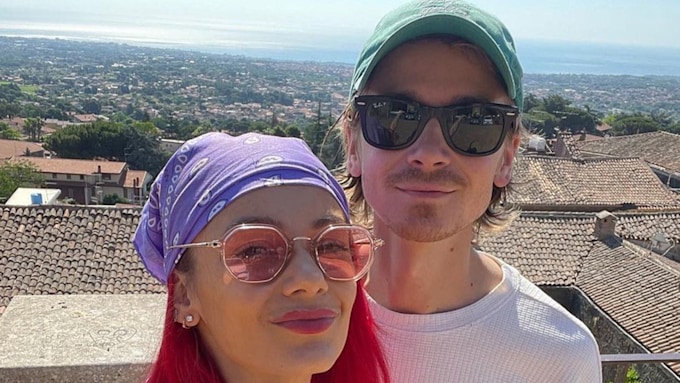 Dianne Buswell and Joe Sugg smiling in a close up photo