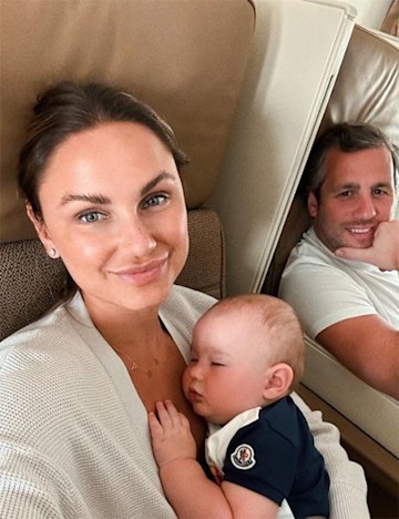 Sam Faiers holding a baby in first class