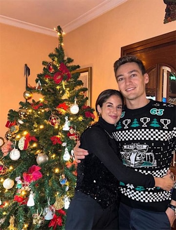 George Russell and Carmen Montero Mundt in front of Christmas tree