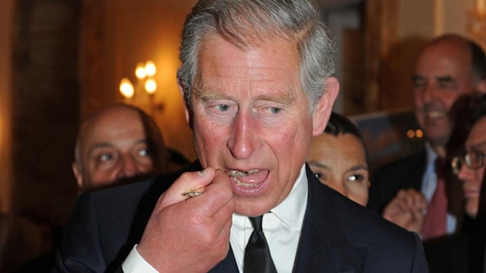 King Charles wearing suit eating