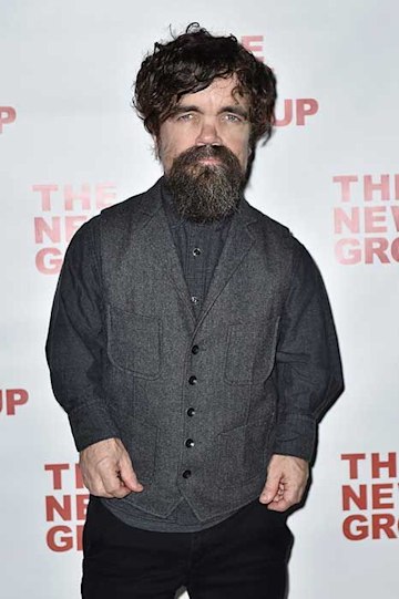 peter wears a beard and stands looking at the camera wearing a charcoal grey shirt with a complementary grey waistcoat over it with black trousers completing the look