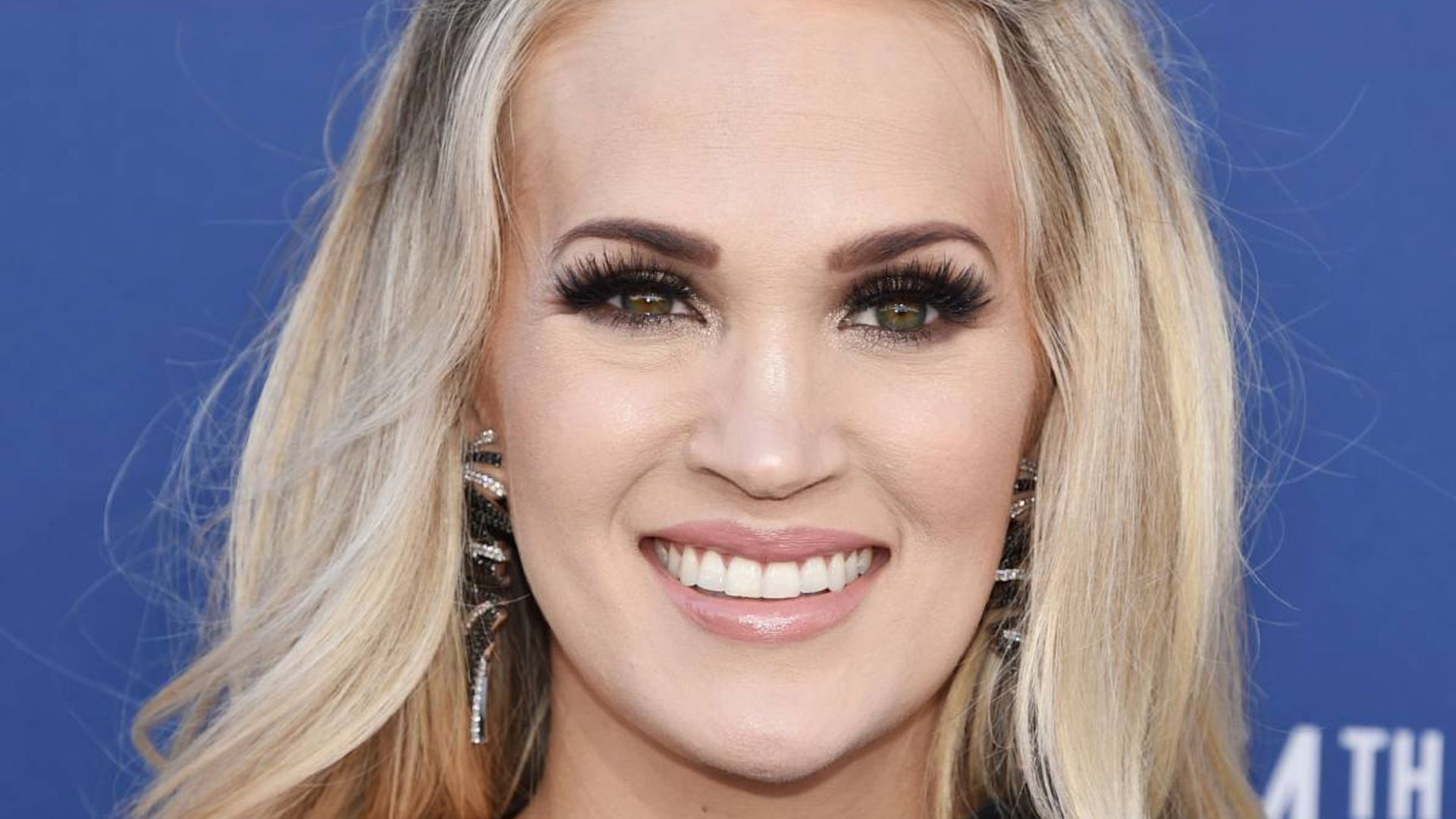 Carrie Underwood is mesmerising in bejewelled low-cut gown with ...