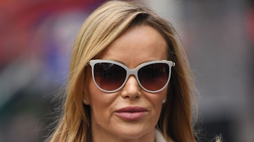 Amanda Holden strikes a pose in leather mini skirt and knee-high boots