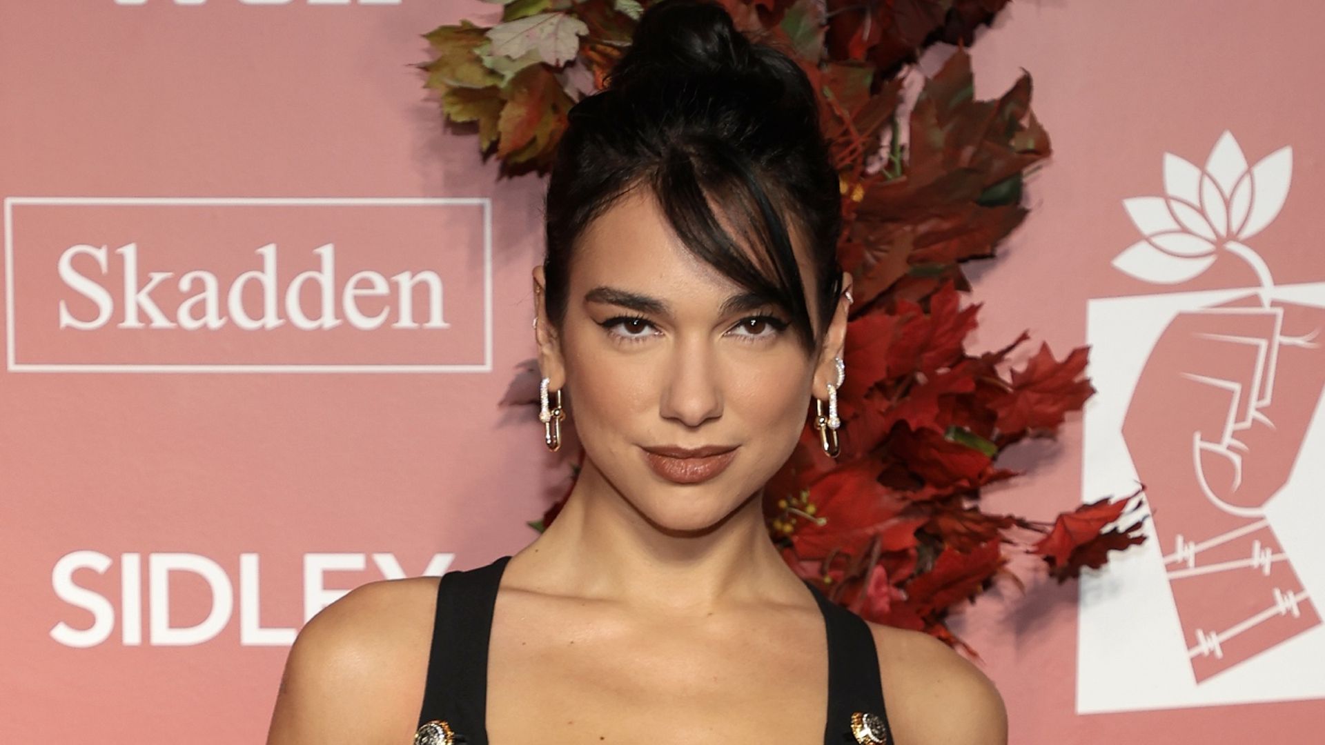 Dua Lipa bares toned legs in skirt with a dangerously high slit | HELLO!