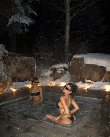 Kylie Jenner sitting in the hot tub with her friend