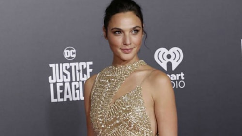 Gal Gadot turns heads in gold at Justice League premiere