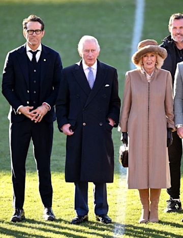 King Charles III and Camilla, Queen Consort meet with co-owner of Wrexham AFC, Ryan Reynolds during their visit to Wrexham AFC on December 09, 2022 in Wrexham, Wales. 