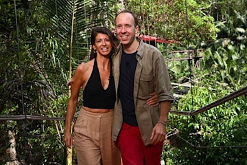 matt and gina pose on the bridge after exiting the jungle