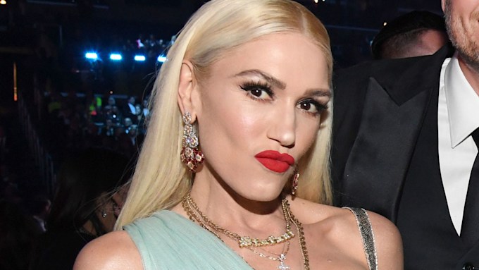 gwen stefani pouts with red lipstick on